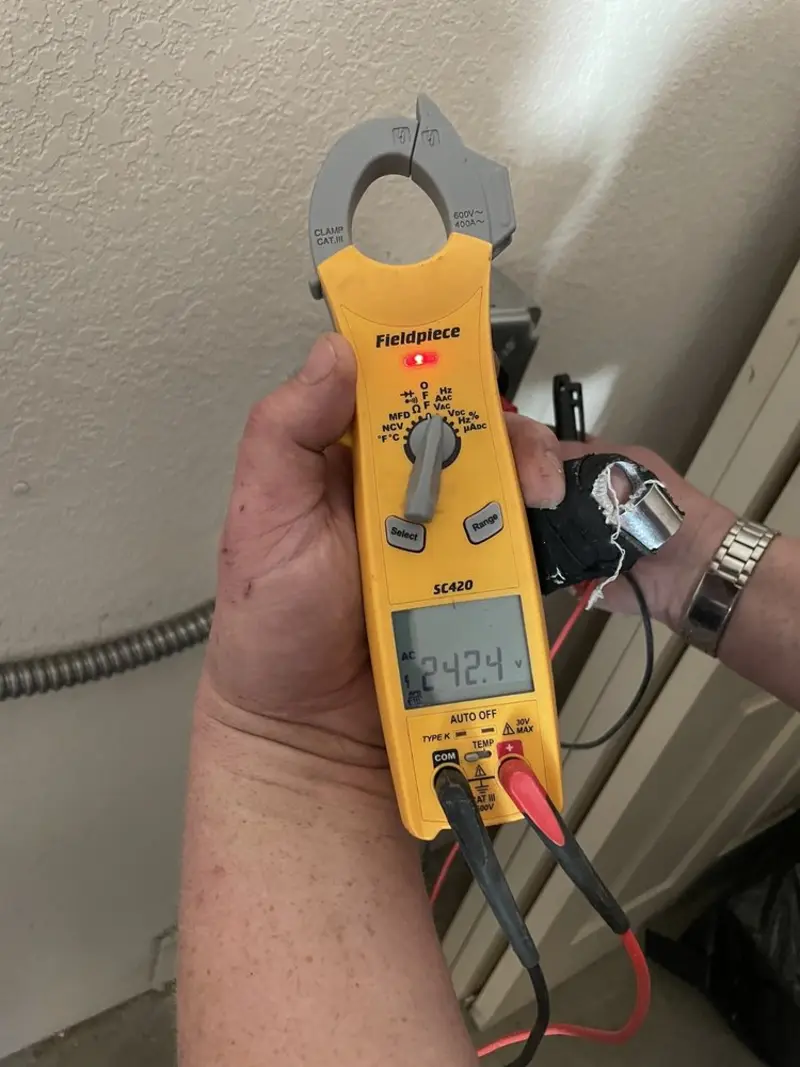 Voltage testing with clamp meter during Outlet Installation in West Clarkston-Highland